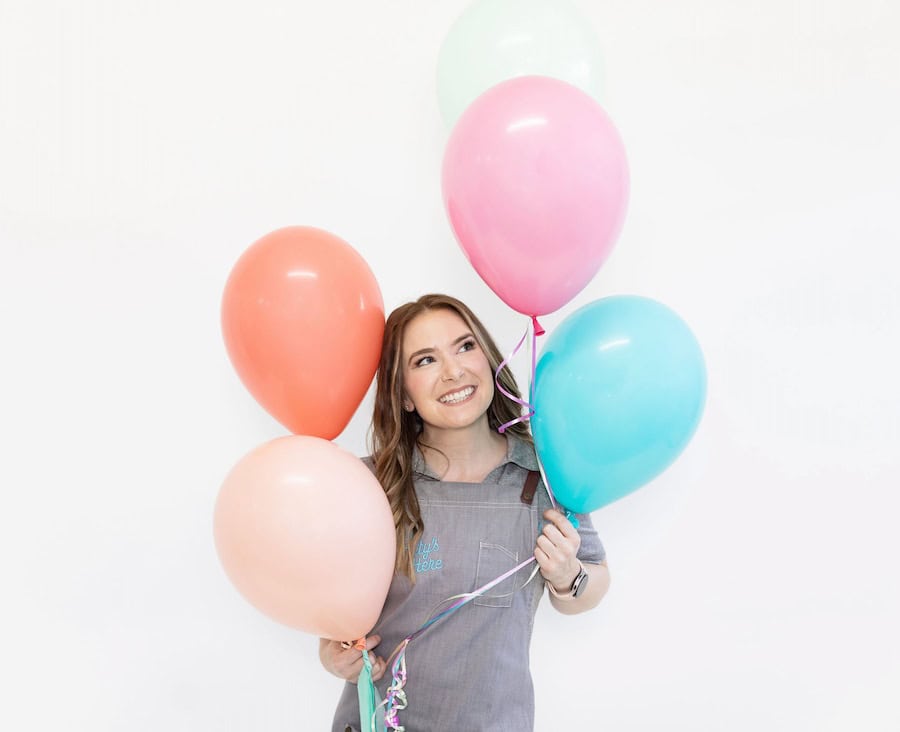 Image of The Party's Here owner Claire holding balloons.