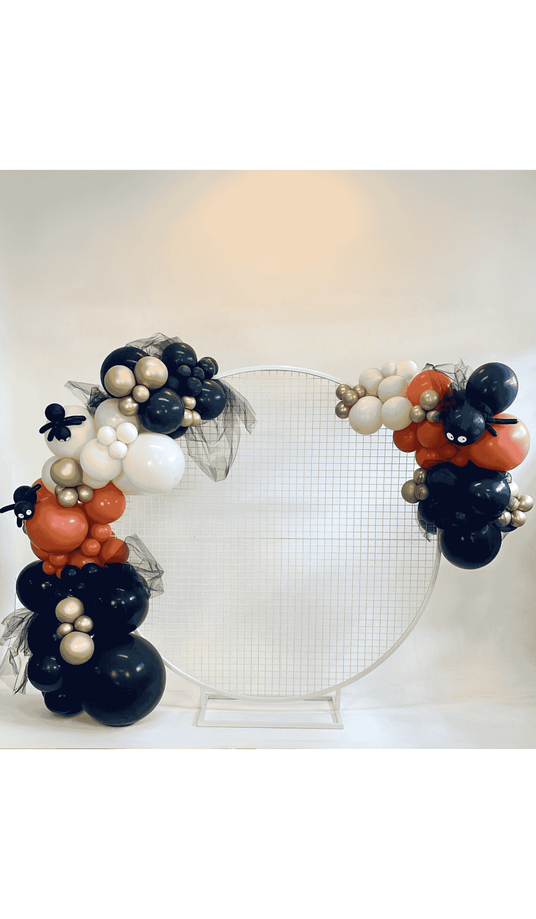 Round white mesh hoop backdrop with organic balloon garland attached