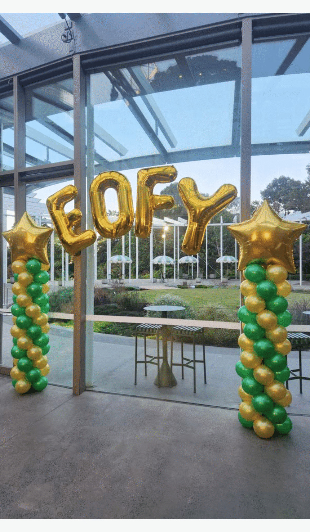 EOFY balloon columns arch large gold foil letters stars