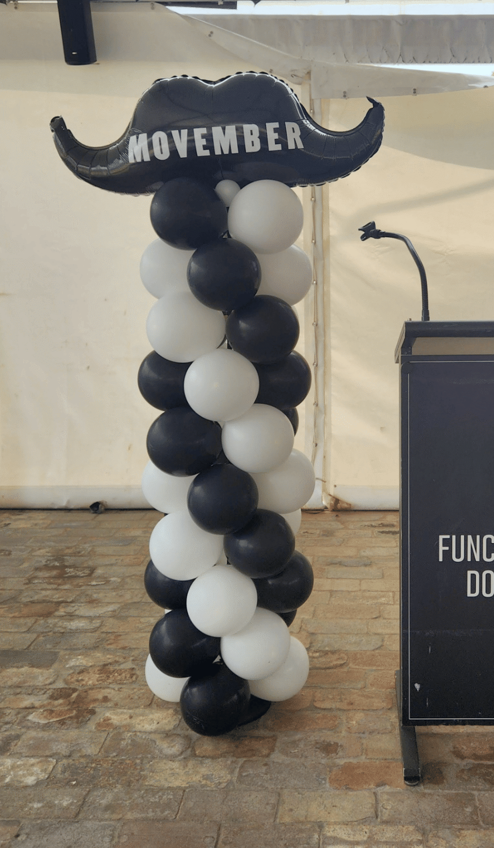 Movember fundraiser moustache garland balloon column black white branded